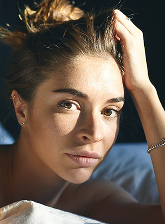 Woman showing results of facial treatment.