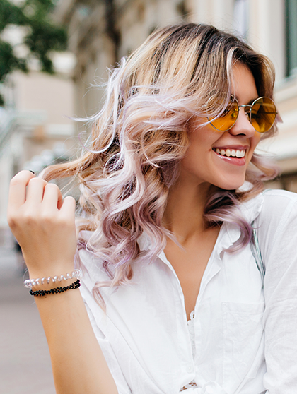 Smiling woman with highlights and tints.
